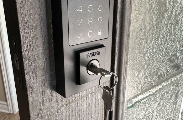 Smart keypad lock with Weiser key installed for secure commercial or residential entry access.
